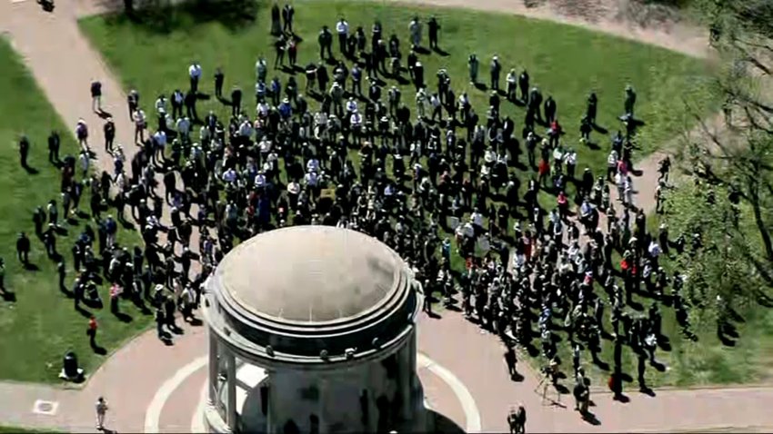 An aerial shot of a crowd gathered around a bandstand at the Boston Common.