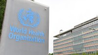 This photo taken on May 21, 2023 shows a logo of the World Health Organization WHO with the WHO headquarters in the background in Geneva, Switzerland.