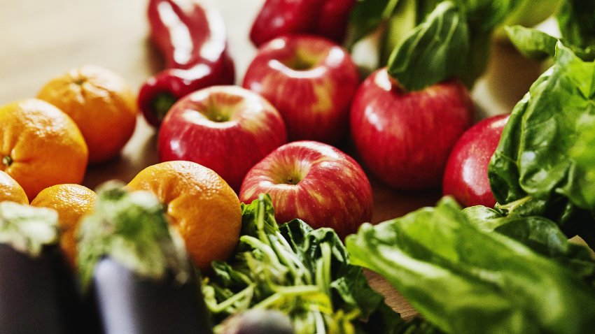 Closeup shot of fresh organic fruit and vegetables on a kitchen counter
