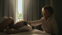 Girl stroking her sleeping mother
