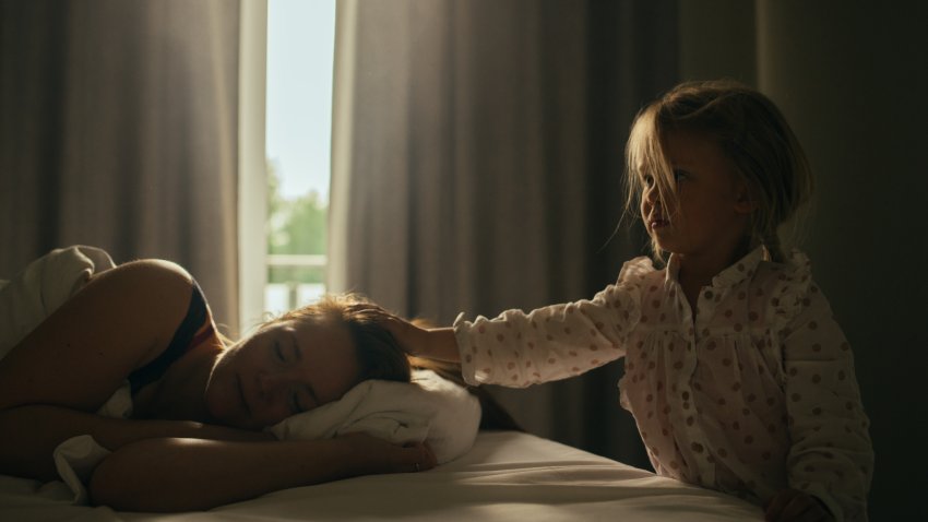 Girl stroking her sleeping mother