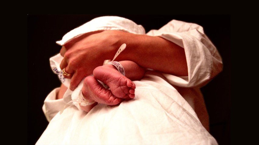 A mother holding a newborn baby