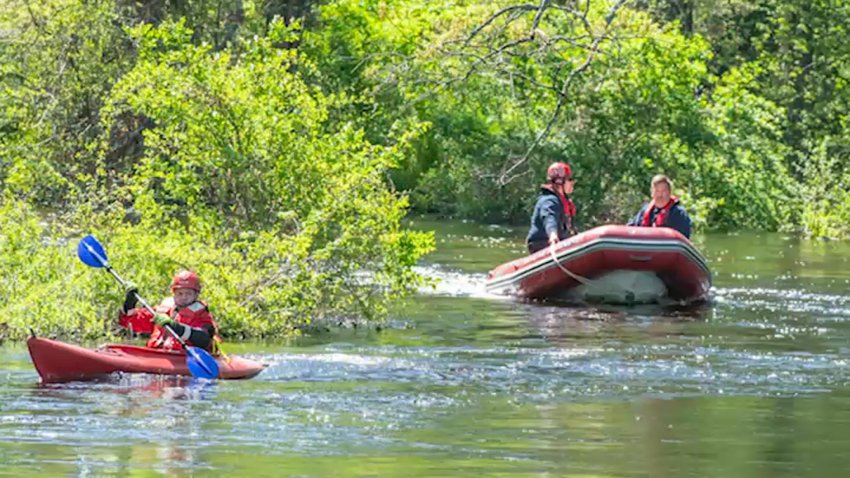 Crews search the water at Beaver Brook in Hudson, New Hampshire for a fisherman who fell in on Sunday, May 11, 2025.