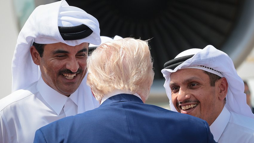 President Donald Trump speaks with Emir of Qatar Tamim bin Hamad al Thani (L) and Mohammed bin Abdulrahman bin Jassim bin Jaber Al Thani (R), Prime Minister of Qatar, as he departs the Al Udeid Air Base for Abu Dhabi on May 15, 2025, in Doha, Qatar.