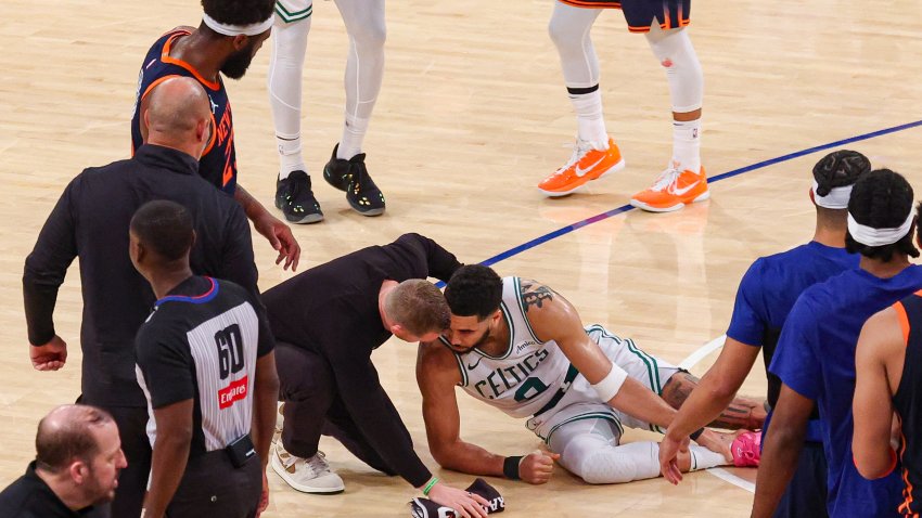 May 12, 2025; New York, New York, USA; Boston Celtics forward Jayson Tatum (0) with a member of the medical staff on the court after an injury in the second half during game four of the second round for the 2025 NBA Playoffs against the New York Knicks at Madison Square Garden. Tatum would leave the game with an injury after this play. Mandatory Credit: Vincent Carchietta-Imagn Images
