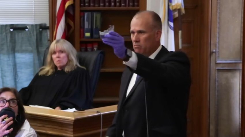 Lt. Paul Gallagher holds up a broken cocktail class, evidence in the Karen Read murder retrial, on Monday, May 5, 2025.