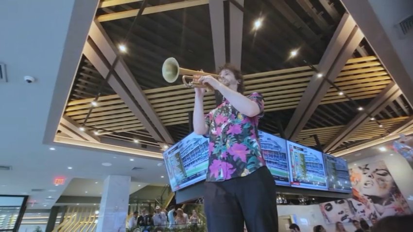 A trumpet player on a counter at Moxies in Boston's Seaport during a Kentucky Derby party on Saturday, May 3, 2025.