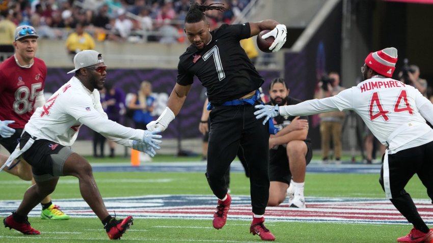 Running back Bijan Robinson of the Atlanta Falcons carries the ball against AFC linebacker Zaire Franklin of the Indianapolis Colts (left) and cornerback Marlon Humphrey of the Baltimore Ravens during the 2025 Pro Bowl Games at Camping World Stadium. — Kirby Lee