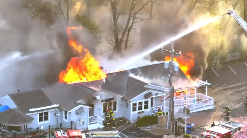 Firefighters battle a blaze at Captain Scott's Restaurant in Sandwich, Massachusetts, on the morning of Sunday, May 4, 2025.