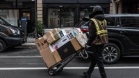 A UPS seasonal worker delivers packages on Cyber Monday in New York on Nov. 27, 2023.