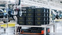 A humanoid robot from UBTech moves a load onto an automated guided vehicle (AGV) in an electric car factory for Geely-backed Zeekr on Aug. 5, 2024, in Ningbo, Zhejiang province of China.