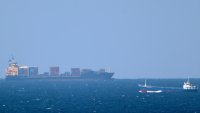 A cargo ship cruises toward the Strait of Hormuz off the shores of Khasab in Oman on Jan. 15, 2011.