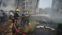 Firefighters work at the site of an airplane that crashed in India's northwestern city of Ahmedabad in Gujarat state, Thursday, June 12, 2025.