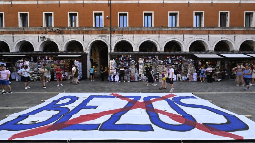 TOPSHOT – People gather to protest against the wedding of Amazon Founder and CEO Jeff Bezos and journalist Lauren Sanchez in Venice, on June 13, 2025. Poster campaigns and stickers have spread throughout the city, including one with images of Bezos reading “No space for Bezos” as some local residents protest claiming the city is transformed into a playground for billionaires. (Photo by ANDREA PATTARO / AFP) (Photo by ANDREA PATTARO/AFP via Getty Images)