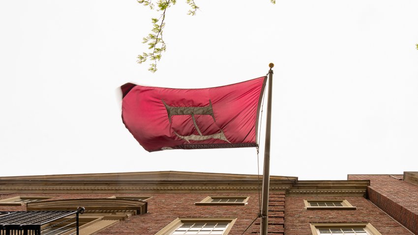A flag displayed on the Harvard University campus in Cambridge, Massachusetts, US, on Monday, May 5, 2025. President Donald Trump said Harvard University would lose its tax-exempt status, stepping up his attack on the Ivy League school with a threat that was decried as out of his jurisdiction. Photographer: Mel Musto/Bloomberg via Getty Images