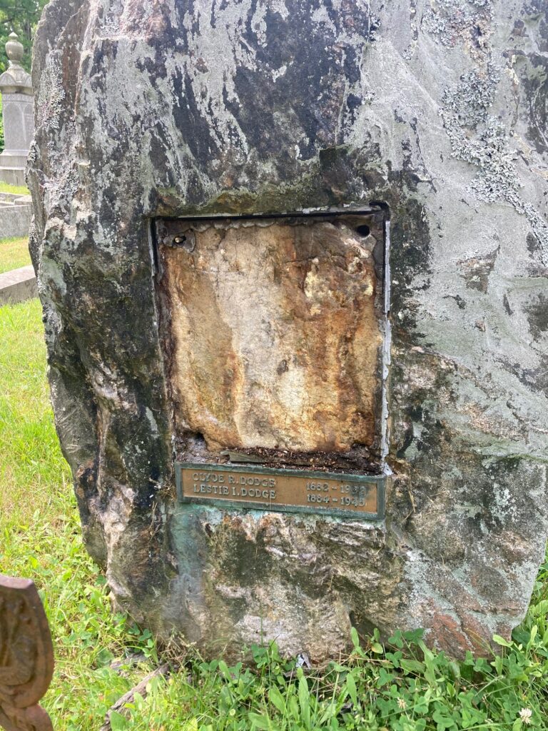 A space where a gravestone's plaque and nameplate were missing at Oak Hill Cemetery in Newburyport, Massachusetts.