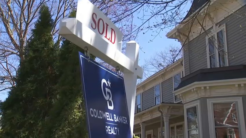 A sold sign next to a home in Boston.