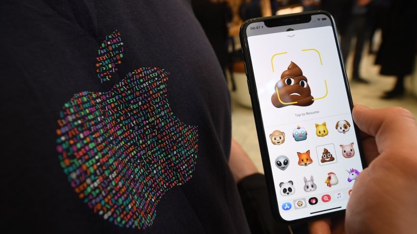 A member of Apple staff pose with a new Apple iPhone X smartphone showing new emoji features in Apple’s Regent Street store in central London on November 3, 2017 after it opened for the first sales of the new smartphone.
Apple’s flagship iPhone X hit stores on November 3, as the world’s most valuable company predicted bumper sales despite the handset’s eye-watering price tag and celebrated a surge in profits. The device features facial recognition, cordless charging and an edge-to-edge screen made of organic light-emitting diodes used in high-end televisions. It marks the 10th anniversary of the first iPhone release and is released in about 50 markets around the world.
 / AFP PHOTO / Chris J Ratcliffe        (Photo credit should read CHRIS J RATCLIFFE/AFP via Getty Images)