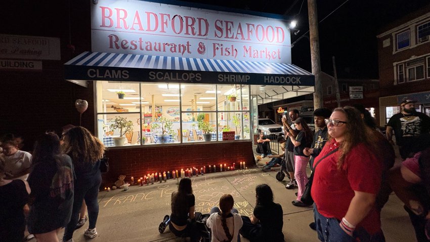 A vigil outside Bradford Seafood in Haverhill, Massachusetts, on July 12, 2025, where a man died during a struggle with police the day prior.