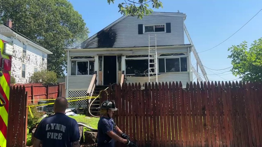 Firefighters on scene at a fire at a home in Lynn, Massachusetts, on July 24, 2025. Fire damage can be seen toward the top off the home