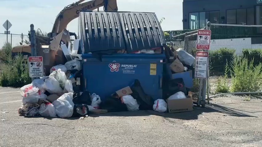 An overflowing Republic Services dumpster.