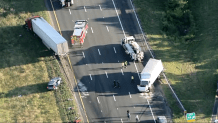 Damaged trucks and first responders on I-95 in Danvers, Massachusetts, on Monday, July 21, 2025.
