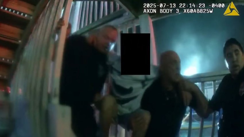 Fall River police officers and a firefighter evacuating a person from the deadly Gabriel House blaze, as seen on an officer's body-worn camera.