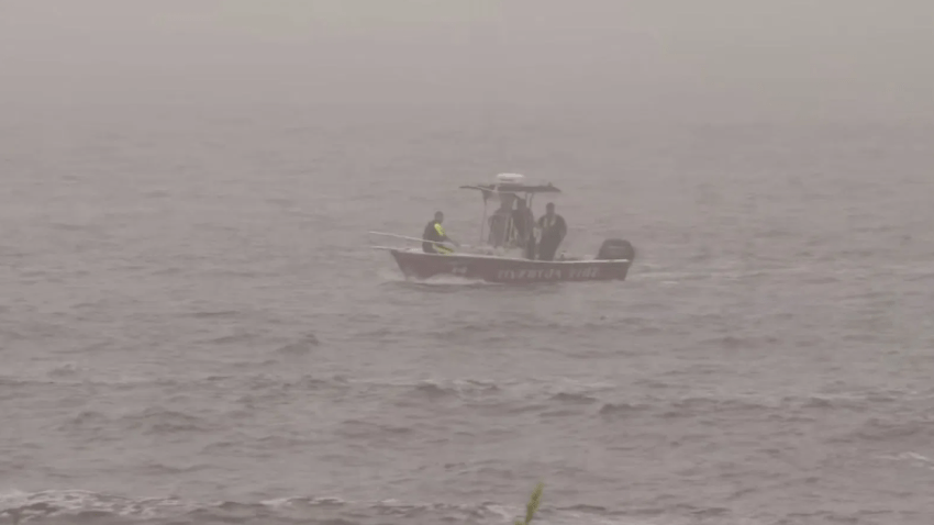 Emergency crews investigate the water near Warren’s Point Beach Club in Little Compton, Rhode Island, to find two missing people on Saturday, July 12, 2025 (WJAR).