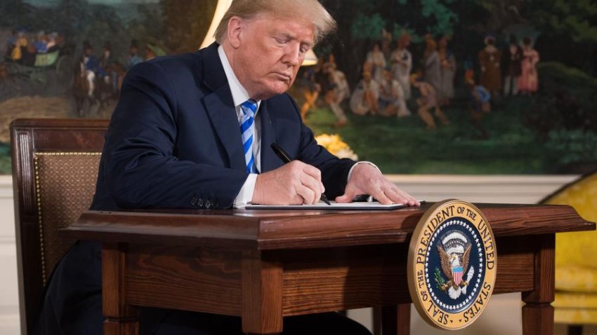 President Donald Trump signs the tax overhaul into law.