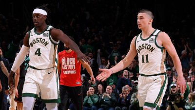 Jrue Holiday (4) and Payton Pritchard (11)