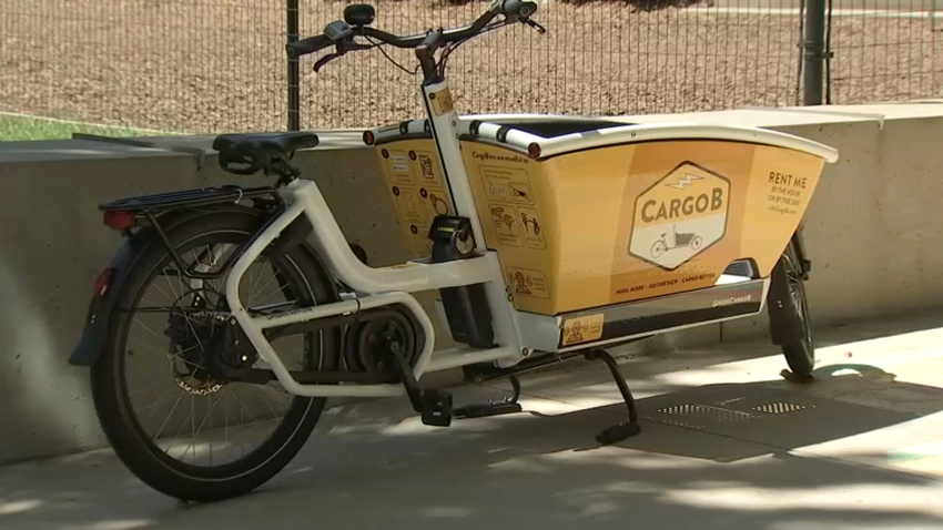 A CargoB cargo e-bike parked on the sidewalk.
