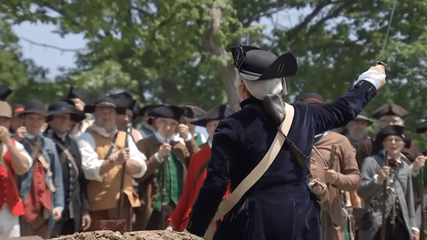 An officer addresses the Lexington Minute Men.