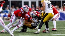 Sep 21, 2025; Foxborough, Massachusetts, USA; Pittsburgh Steelers running back Jaylen Warren (30) is tackled by New England Patriots linebacker Robert Spillane (14) and New England Patriots cornerback Carlton Davis III (7) during the third quarter at Gillette Stadium. Mandatory Credit: Paul Rutherford-Imagn Images