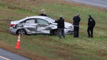 NTSB officials document the damage to a vehicle involved in a fatal plane crash on I-195 in Dartmouth.