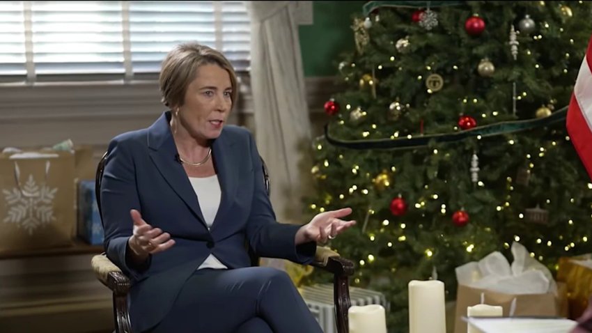 Massachusetts Governor Maura Healey sits next to a Christmas tree