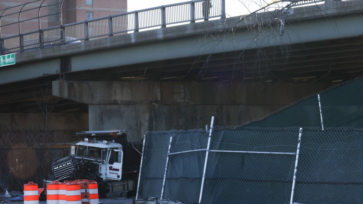 Dump truck crashes through guardrail, goes off overpass in Boston