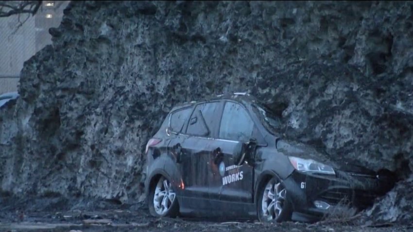 A car half-buried in a huge pile of snow in Somerville, Massachusetts, as seen on Tuesday, April 14, 2026.