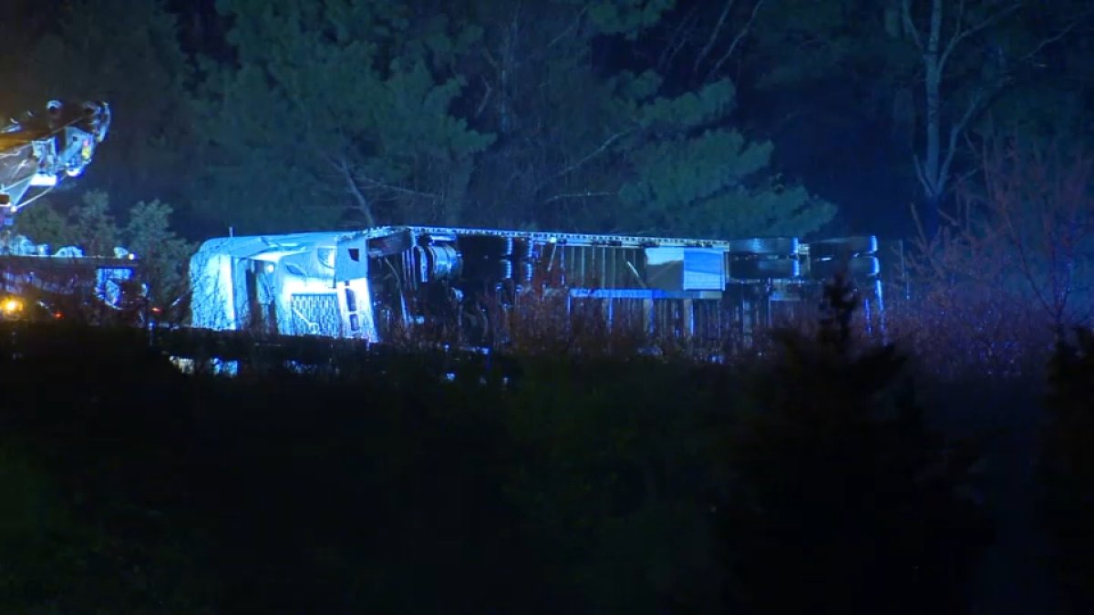 Tractor-trailer rolls over on Mass. Pike in Weston