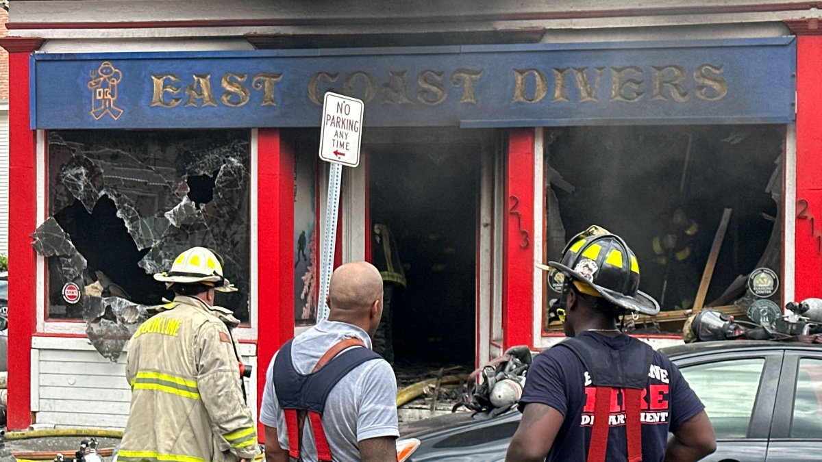 Worker burned during fire, explosions at Brookline dive shop