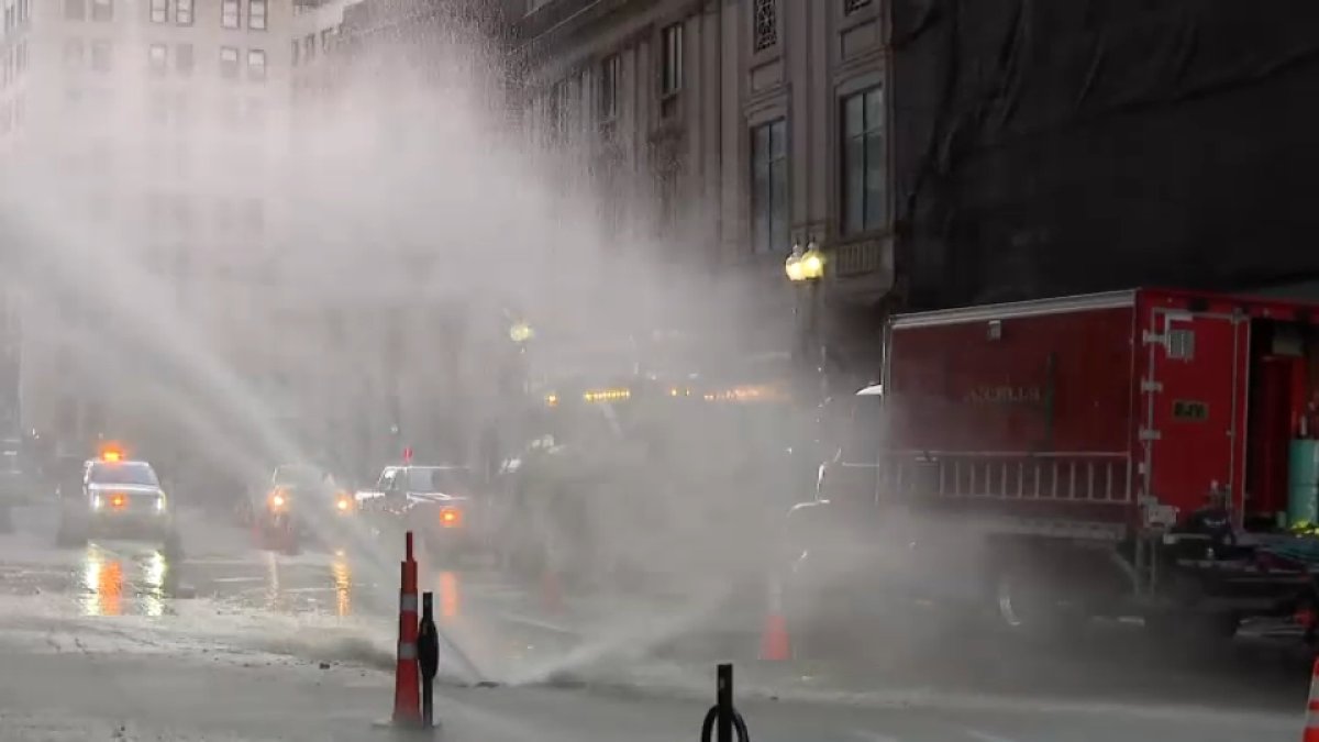 Water shoots from the street in Boston, impacting traffic