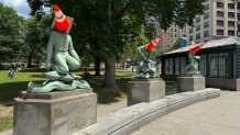 Traffic cones atop statues honoring religion, learning and industry in Boston Common on Wednesday, June 17, 2026.
