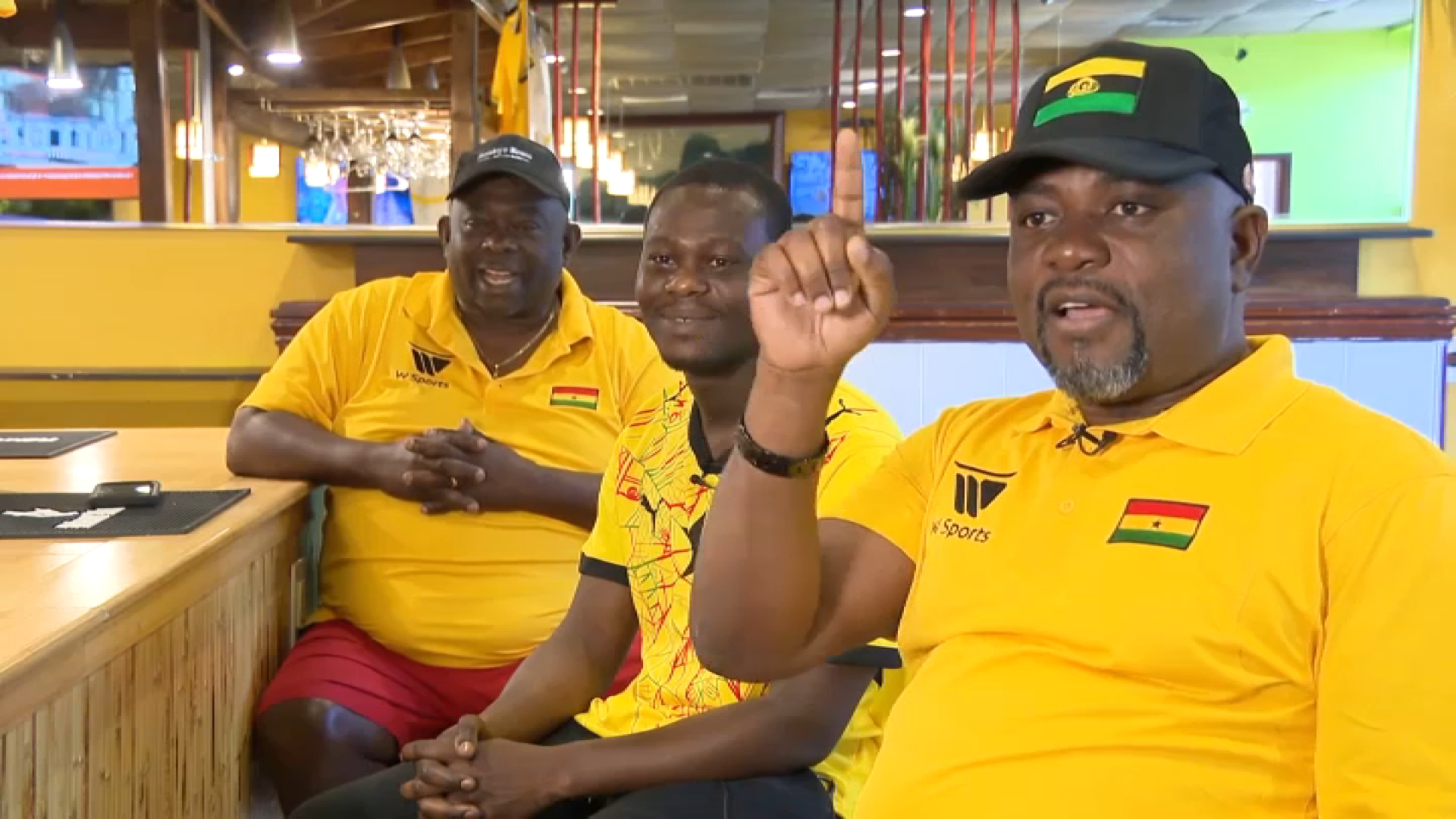 Ghana soccer fans Richard and Isaac Boateng and Kwame Kesse at Anokye Krom, Richard Boateng's restaurant in Worcester, Massachusetts.