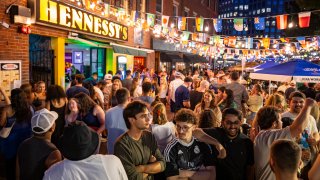 Boston, MA – June 20: People mingle outside Hennessy’s on June 20, 2026. (Photo by Christian Kantosky/The Boston Globe via Getty Images)