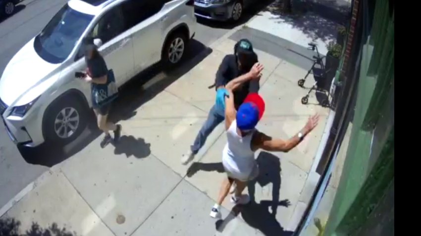 A man being shoved by a person who'd just gotten off a bicycle in East Boston on Friday, July 24, 2026.