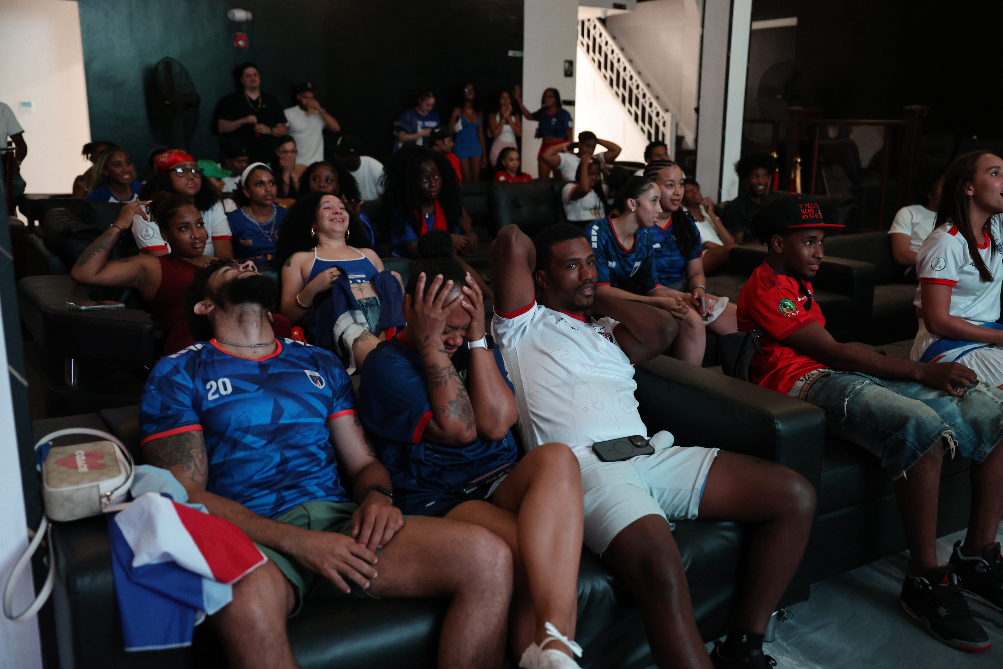 From left: Ivan Andrade, Analise Gomes and John Gomes react at a FIFA World Cup watch party of the Cape Verde vs. Argentina Round of 32 match at Ann's Place in Brockton, Massachusetts, on Friday, July 3, 2026.