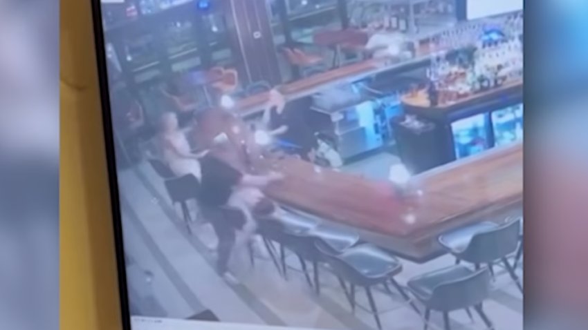 A still from surveillance video showing a patron punching another at a bar in Quincy, Massachusetts.