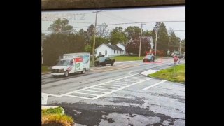 Surveillance video showing a U-Haul truck passing traffic with a Massachusetts State Police cruiser in pursuit.