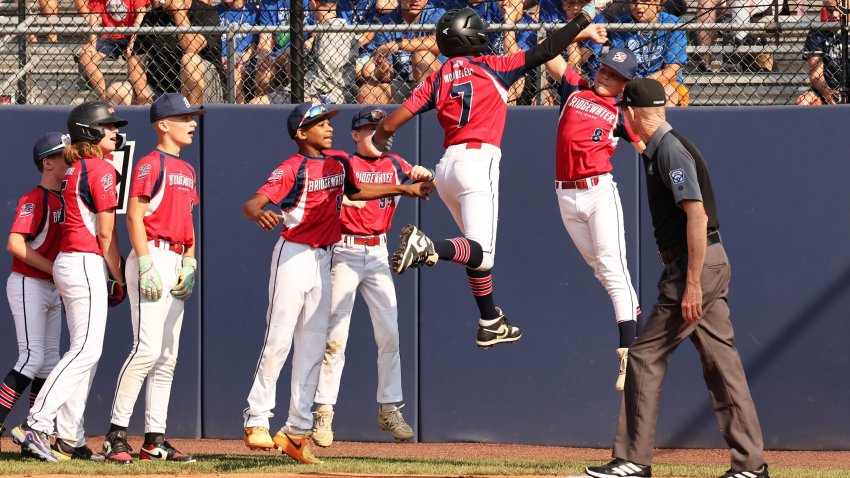 Bridgewater’s Dominik Mombeleur hits a home run and high-fives Luke Schlatz against Vermont (Camels Hump) in the New England Tournament at the A. Bartlett Giamatti Little League Leadership Training Center in Bristol, CT on Monday, August 10, 2026.
