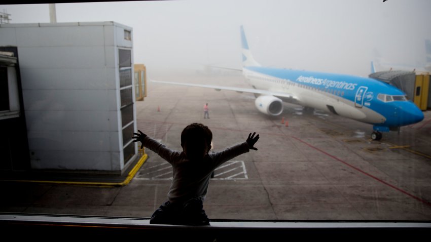 A child watches a plane at the Jorge Newbery airport in Buenos Aires, Argentina