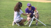 Members of the Science Club for Girls prepare to launch a rocket.